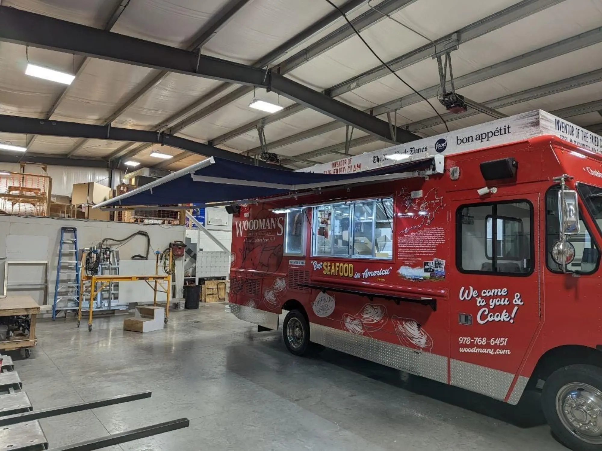 Woodman's truck, outside, view of the right side with awning up