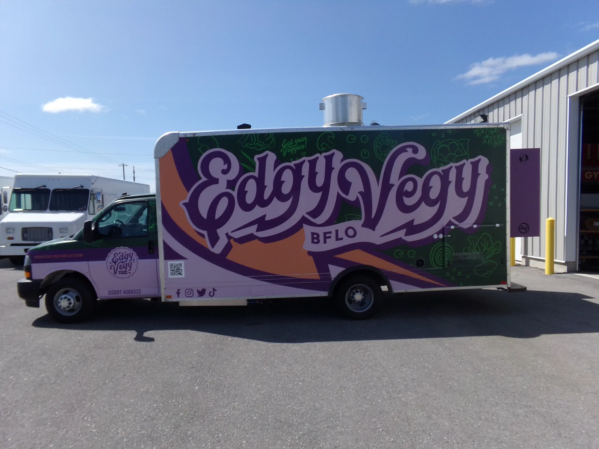 Edgy Vegy Buffalo truck, outside, left side with truck logo