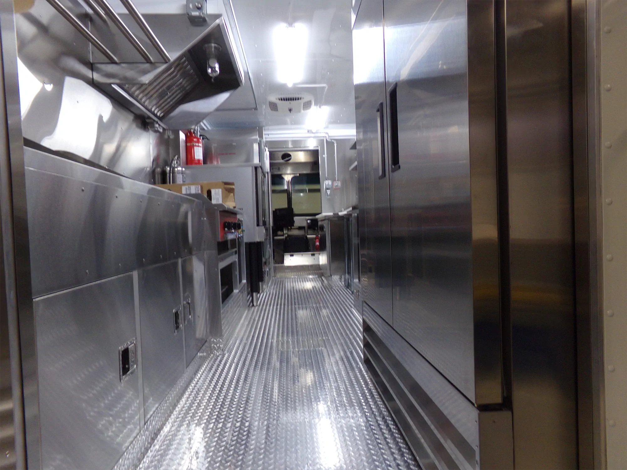 Real Food On The Move truck, inside, looking down the truck at the door to the cab