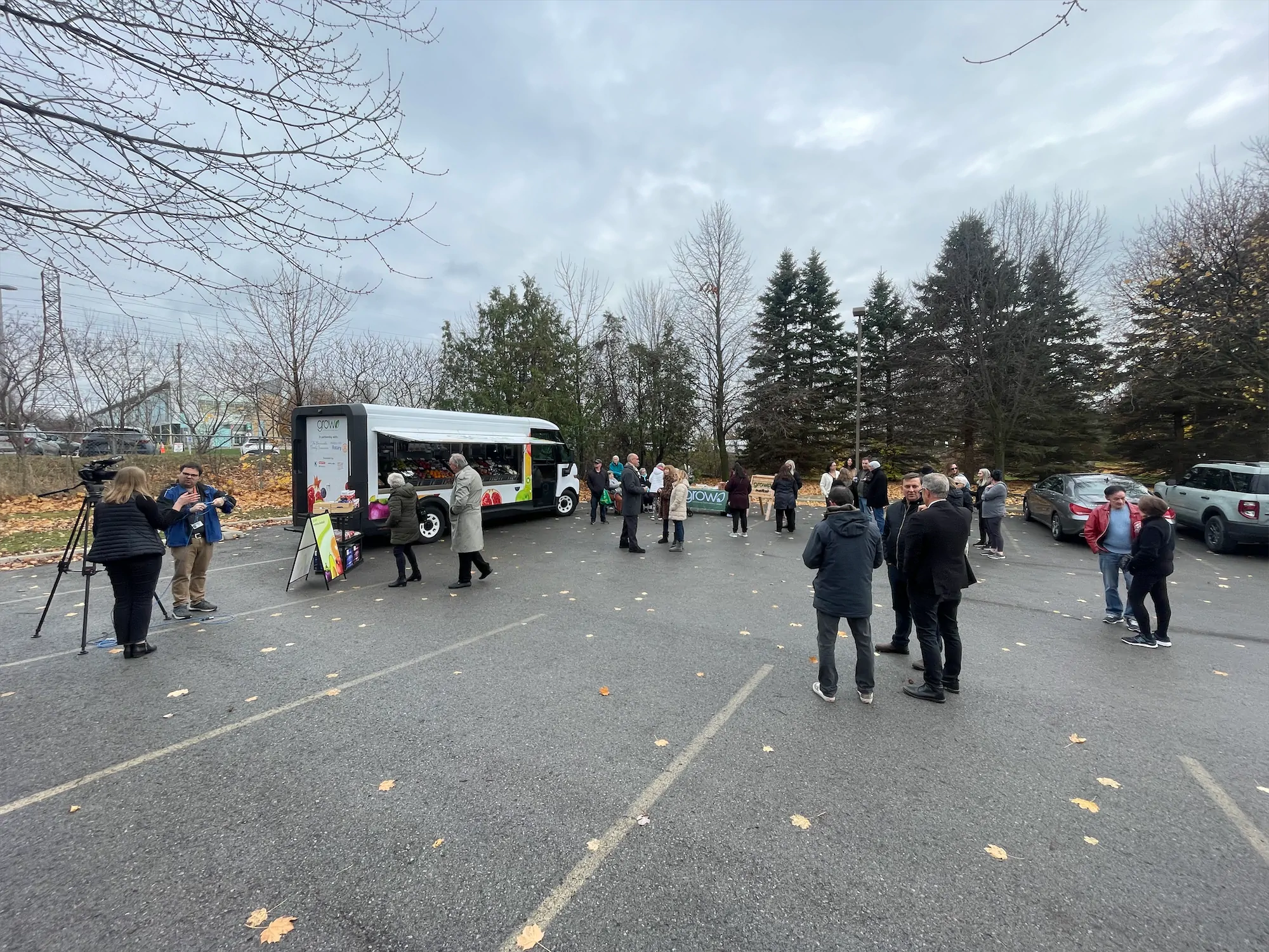 Grow of the Go truck, outside, right side with windows open and people standing around