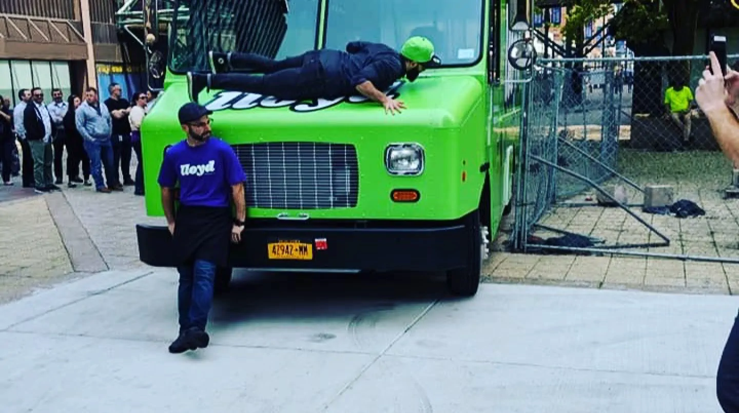 Lloyd Taco truck number 5 with the owners hanging out by the front of the truck