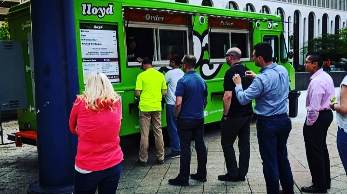 Lloyd Taco truck number 5 with customers waiting in line to get food